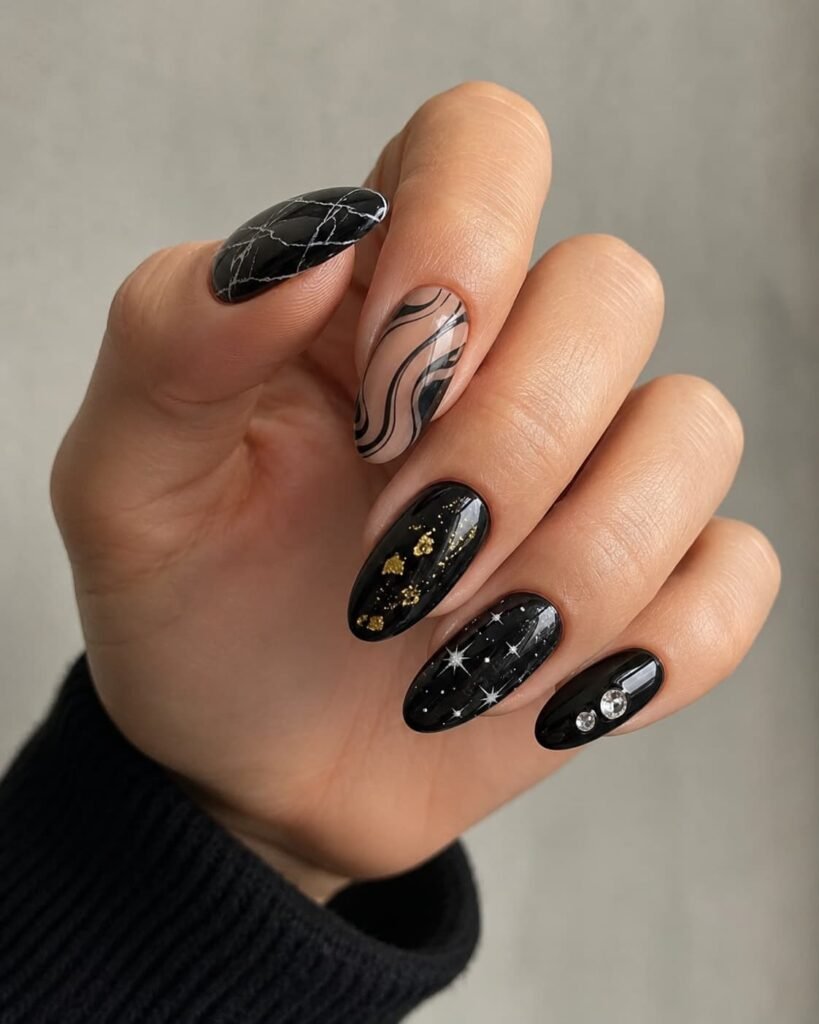 Decorative black nails with marble, swirls, gold accents, stars, and rhinestones