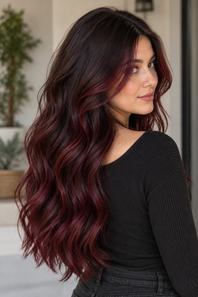 Dark brunette hair with burgundy balayage, dark roots, and face-framing pieces