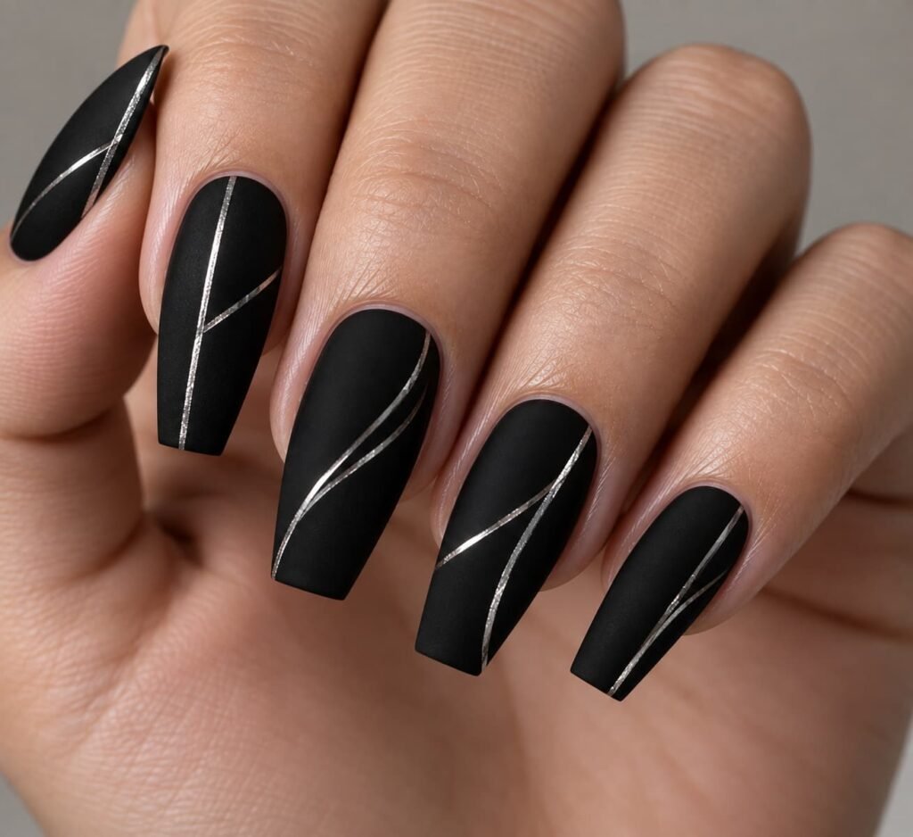 Medium coffin nails with a matte black finish and minimalist metallic silver geometric lines.