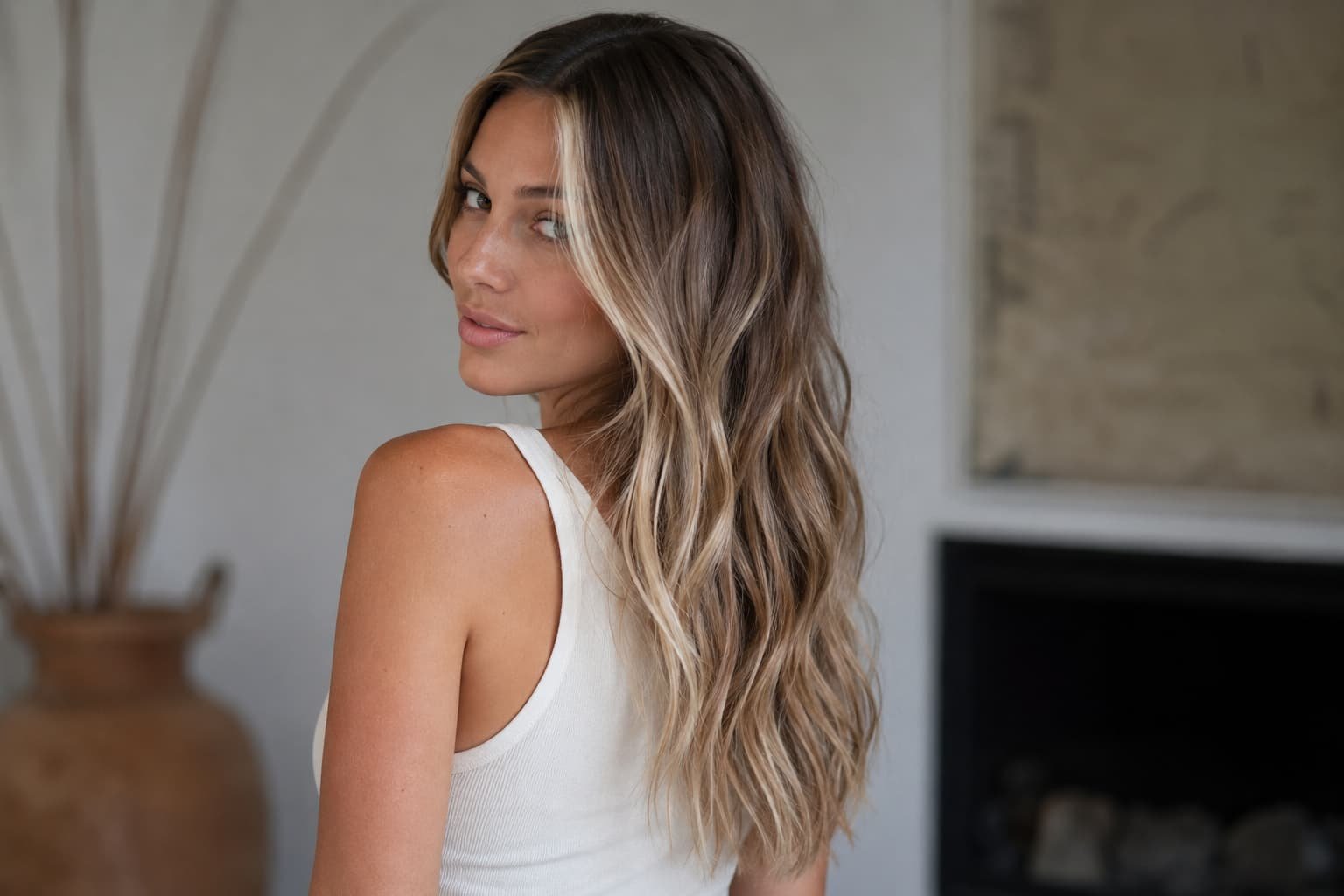 Long wavy hair with dimensional blonde balayage and darker roots